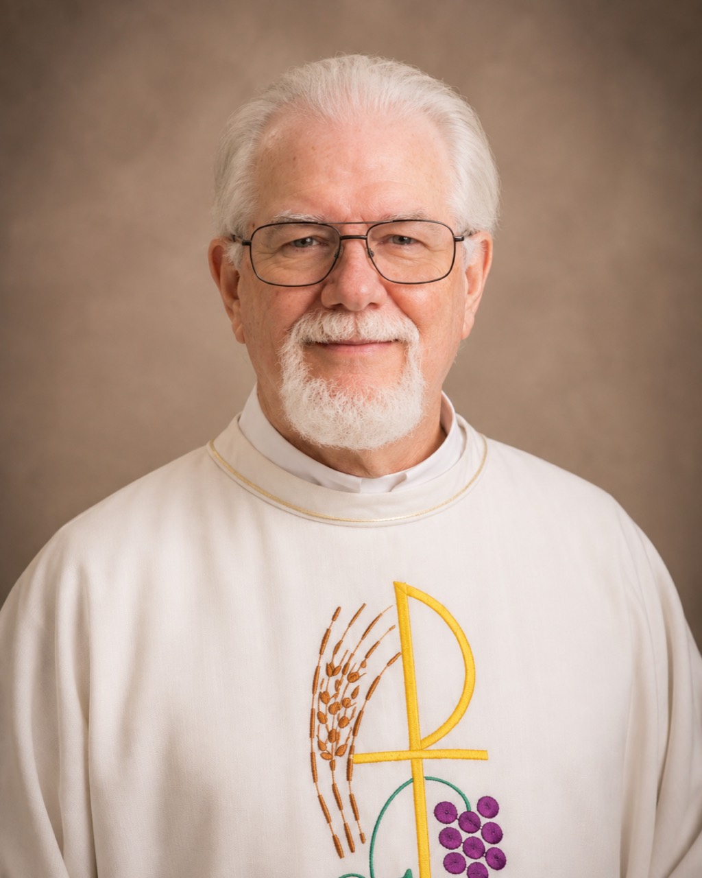 Fr. Mark Schmidt in white vestments, smiling warmly